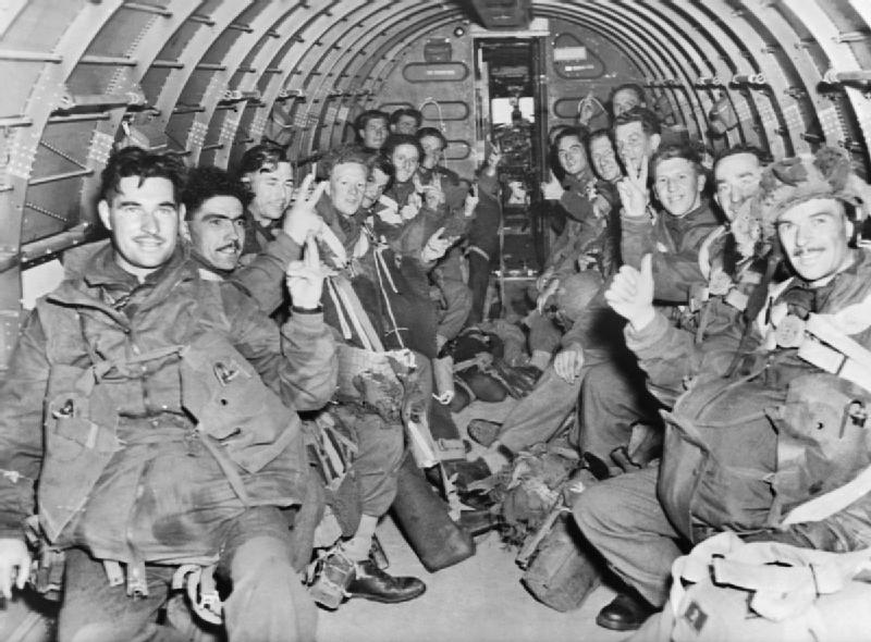 British Paratroops of 1st (British) Airborne Division give the 'V'-sign and "thumbs up" inside one of the C-47 transport aircraft.